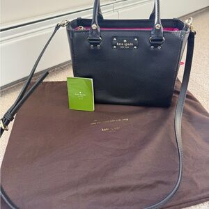 Kate Spade black pebble leather bag with gold hardware and bright pink liner.